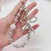 Light Luxury Style Electroplated Bow Inlaid Diamond Beads Mobile Phone Chain Student Bag Pendant_viptrois.com