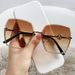 New frameless cut edge women's fashion, with a large metal frame and gradient purple light sunglasses for driving_viptrois.com